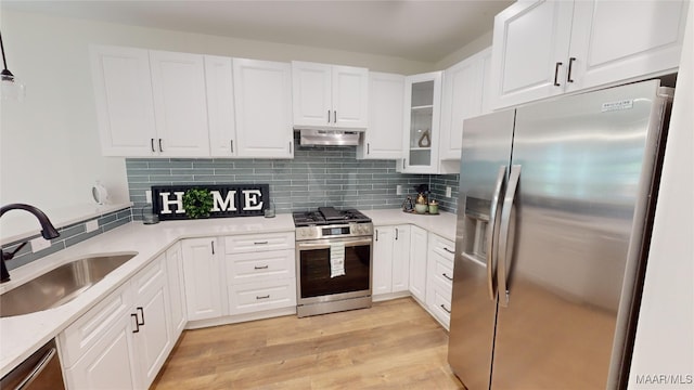 kitchen featuring light wood-type flooring, white cabinetry, appliances with stainless steel finishes, and sink