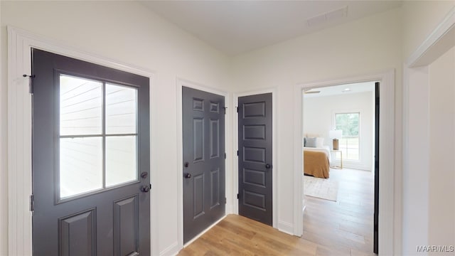 doorway to outside with light wood-type flooring