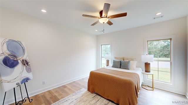 bedroom with ceiling fan and light wood-type flooring