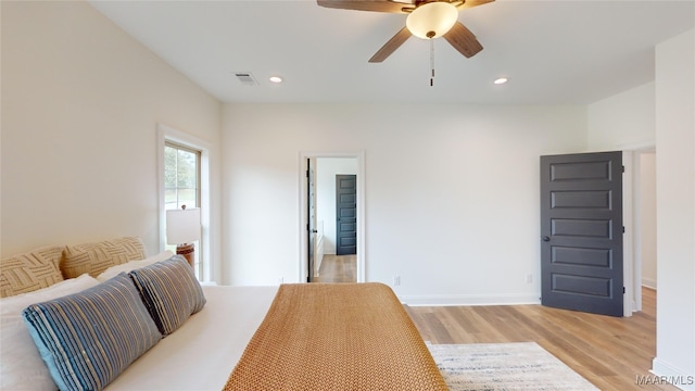 bedroom with light hardwood / wood-style floors and ceiling fan