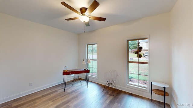 unfurnished room featuring ceiling fan, hardwood / wood-style flooring, and plenty of natural light