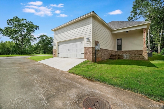 view of home's exterior featuring a garage and a lawn