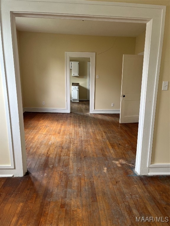 unfurnished room with dark hardwood / wood-style flooring