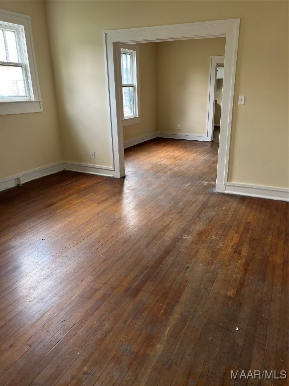 spare room featuring hardwood / wood-style floors and a wealth of natural light