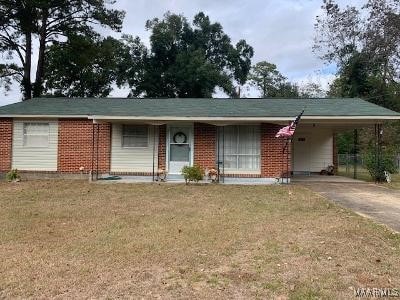 ranch-style home with a carport and a front yard