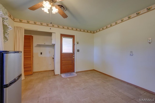 interior space featuring white cabinets, stainless steel fridge, and ceiling fan