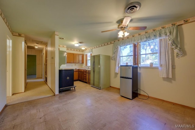 kitchen with stainless steel fridge, sink, and ceiling fan