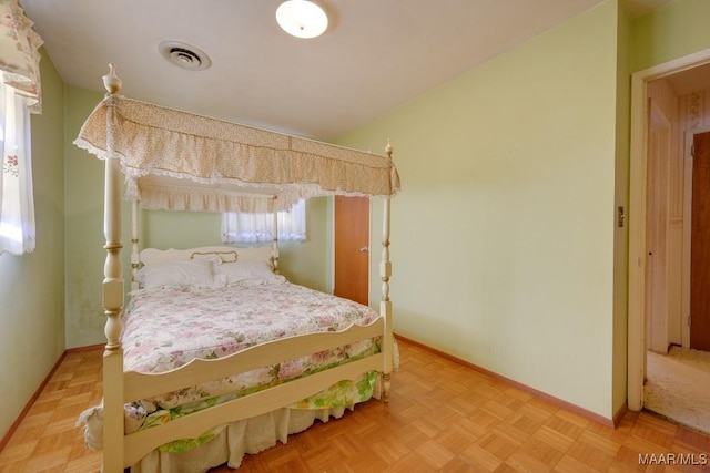 bedroom with light parquet flooring