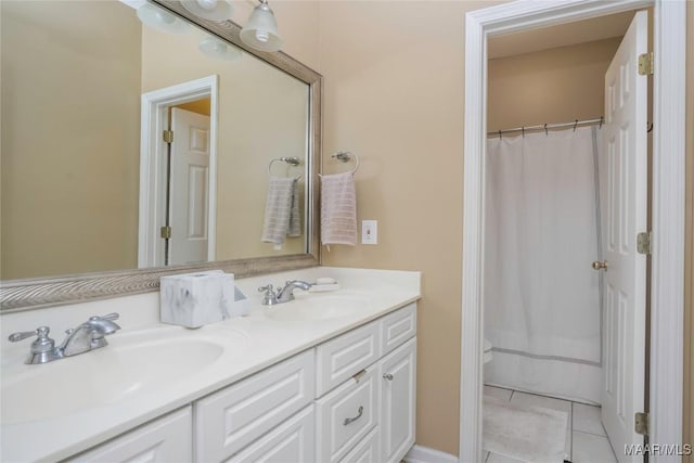 bathroom featuring a shower with curtain, vanity, tile patterned floors, and toilet