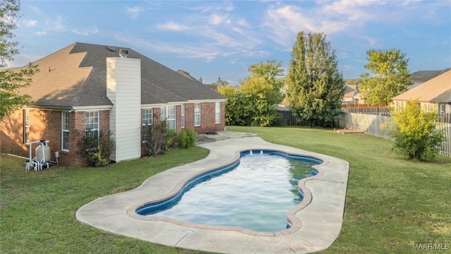 view of swimming pool with a lawn