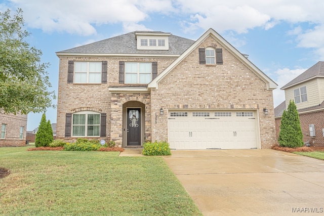 view of front of property with a garage and a front yard