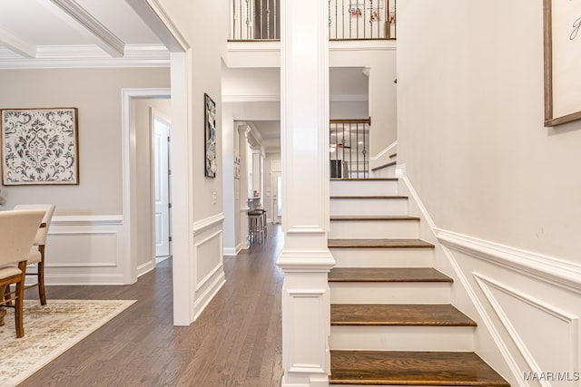 staircase with crown molding and hardwood / wood-style floors