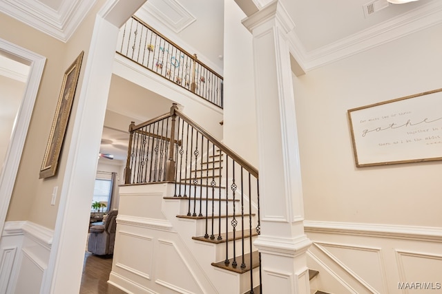 stairs with hardwood / wood-style flooring and crown molding