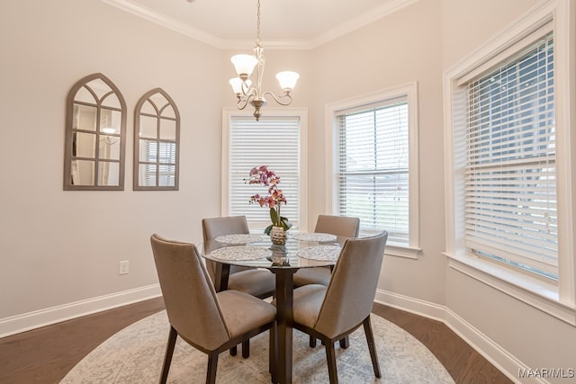 dining room featuring a notable chandelier, crown molding, and dark hardwood / wood-style flooring