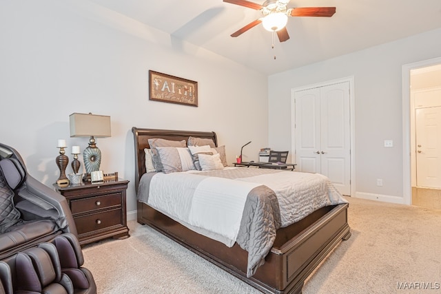 carpeted bedroom with ceiling fan and a closet