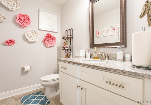 bathroom featuring vanity, toilet, and tile patterned floors