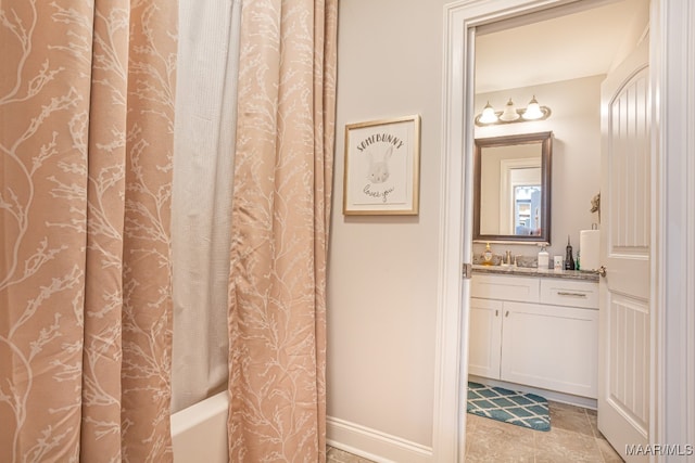 bathroom featuring shower / bath combo with shower curtain and vanity