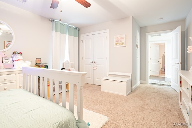 carpeted bedroom featuring a closet and ceiling fan