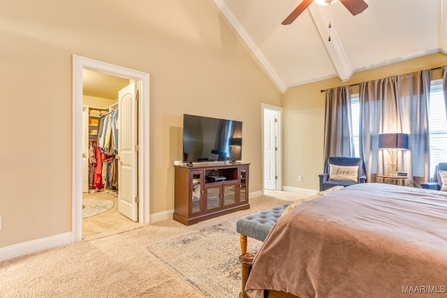 carpeted bedroom with a closet, beamed ceiling, high vaulted ceiling, a spacious closet, and ceiling fan