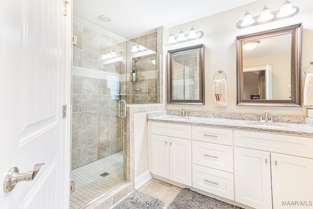 bathroom featuring vanity, tile patterned floors, and an enclosed shower