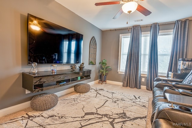 carpeted living room with ceiling fan