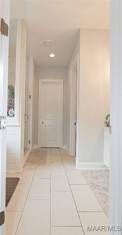 corridor featuring light tile patterned floors