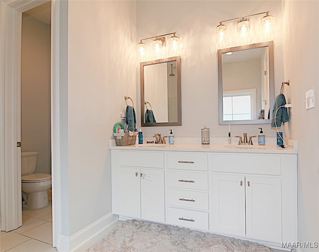 bathroom with vanity, toilet, and tile patterned floors