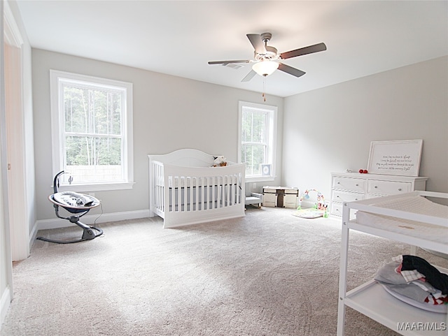 bedroom featuring carpet flooring, multiple windows, and ceiling fan