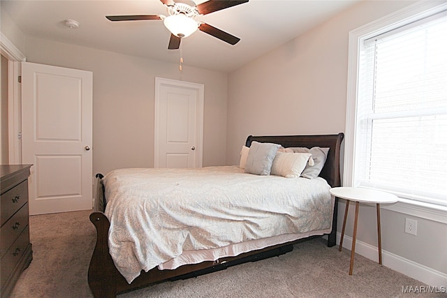 bedroom featuring dark carpet and ceiling fan