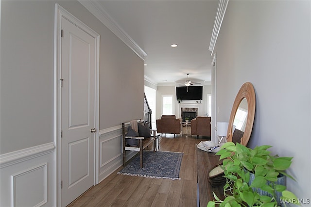 hall with ornamental molding and hardwood / wood-style floors