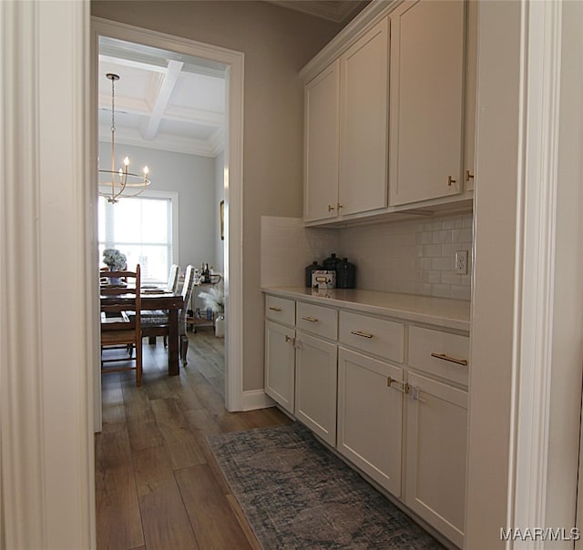 kitchen featuring white cabinets, beamed ceiling, tasteful backsplash, coffered ceiling, and dark hardwood / wood-style floors