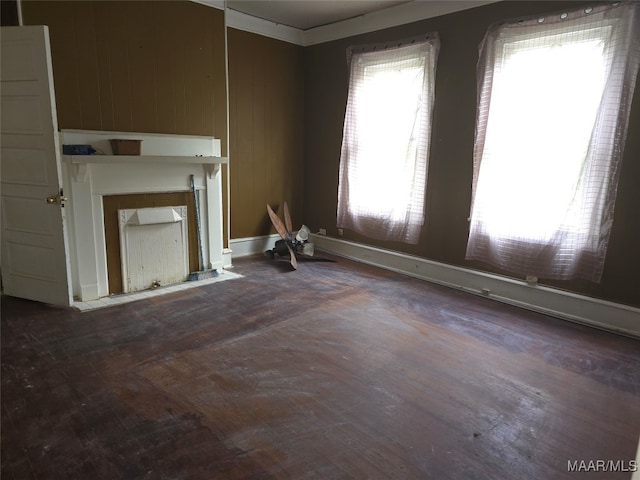 unfurnished living room featuring wood walls