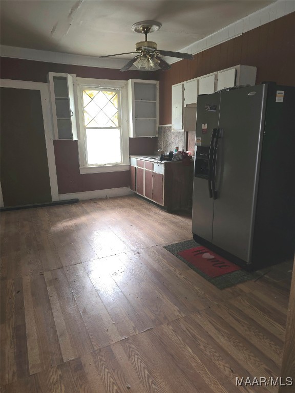 kitchen featuring decorative backsplash, ceiling fan, hardwood / wood-style flooring, and stainless steel fridge