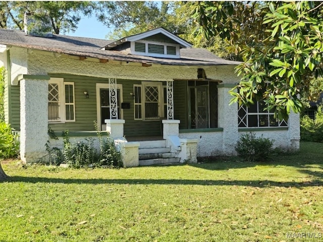 bungalow-style house featuring a front lawn and covered porch