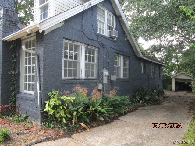 view of side of property with an outdoor structure and a garage