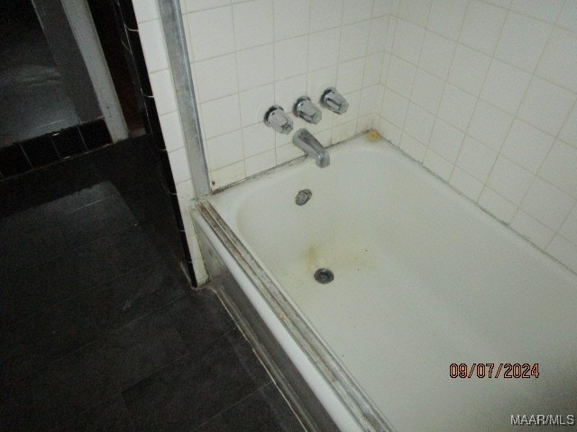 bathroom featuring tiled shower / bath and tile patterned flooring