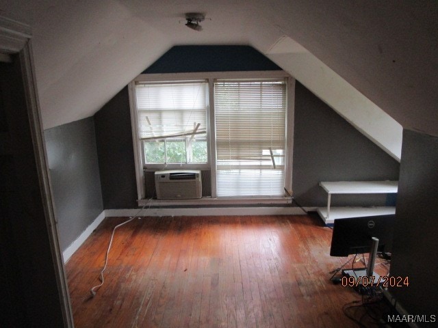 bonus room featuring wood-type flooring, lofted ceiling, and cooling unit