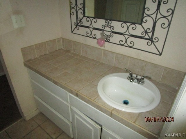 bathroom featuring backsplash, tile patterned flooring, and vanity