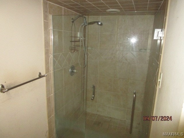 bathroom featuring a shower with shower door