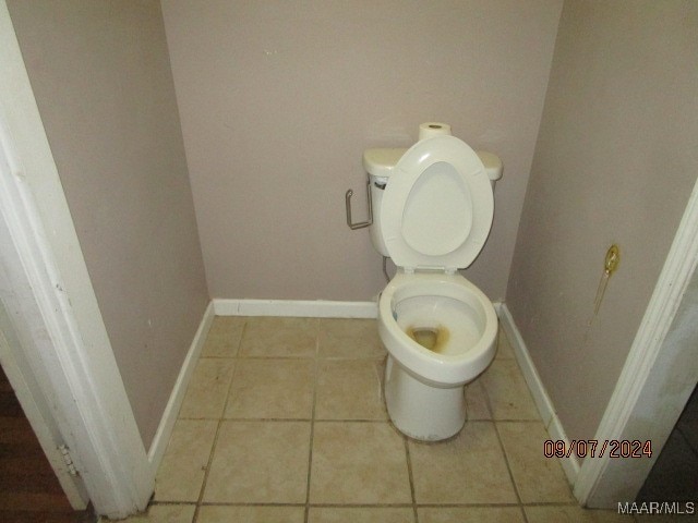 bathroom featuring toilet and tile patterned floors