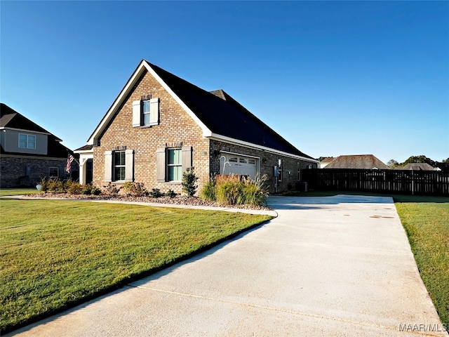 view of front of home featuring a front yard and a garage