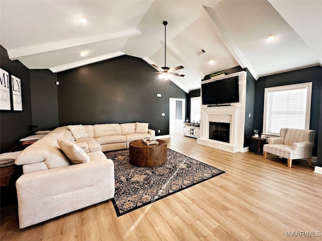 living room with a premium fireplace, light hardwood / wood-style floors, and ceiling fan