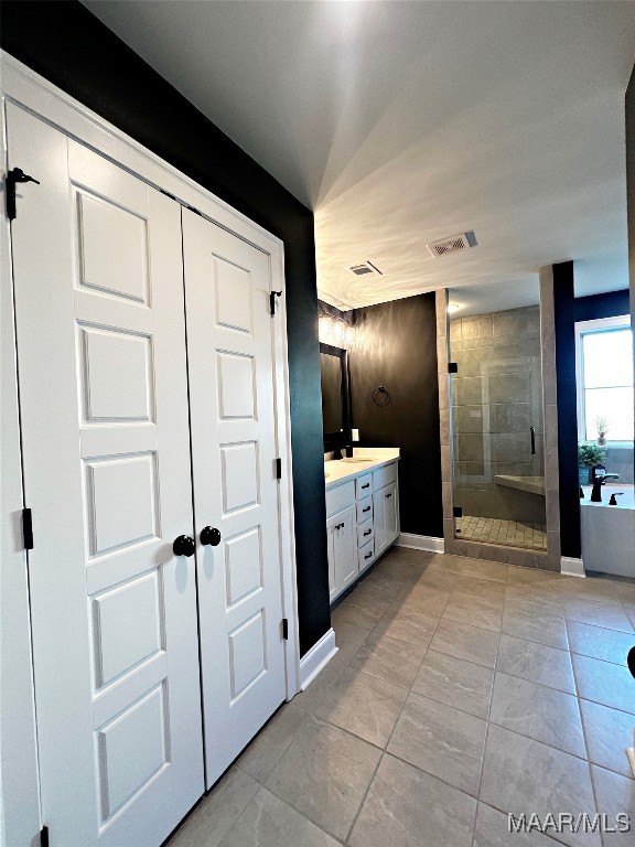 bathroom with independent shower and bath and vanity