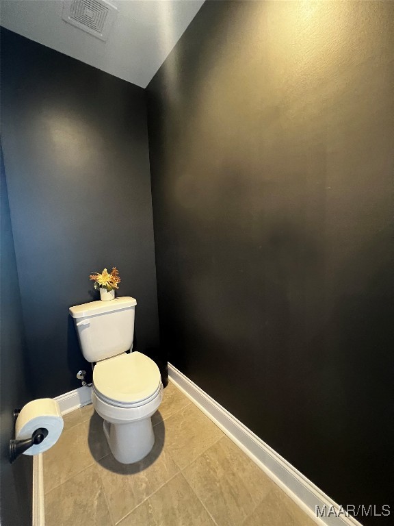 bathroom featuring tile patterned flooring and toilet