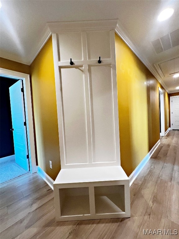 interior space featuring light wood-type flooring and ornamental molding