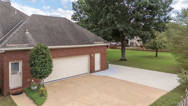 garage featuring a lawn