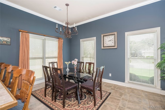 dining area with a notable chandelier, a healthy amount of sunlight, and crown molding