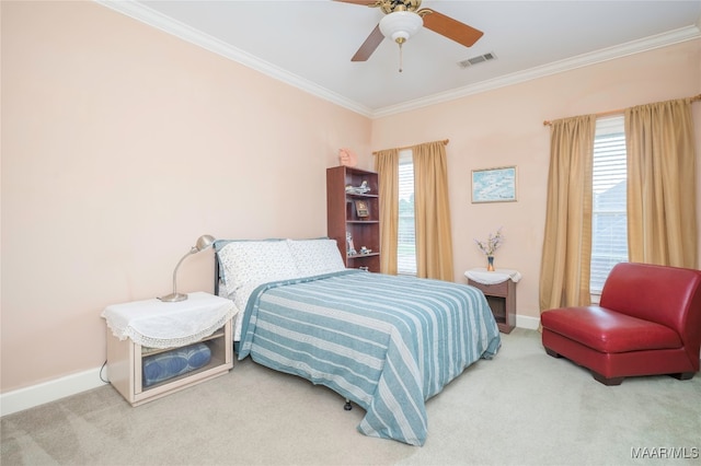 carpeted bedroom with multiple windows, ceiling fan, and ornamental molding