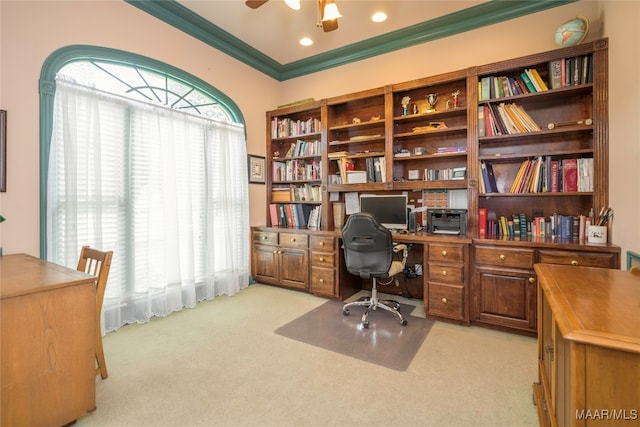 carpeted home office featuring crown molding