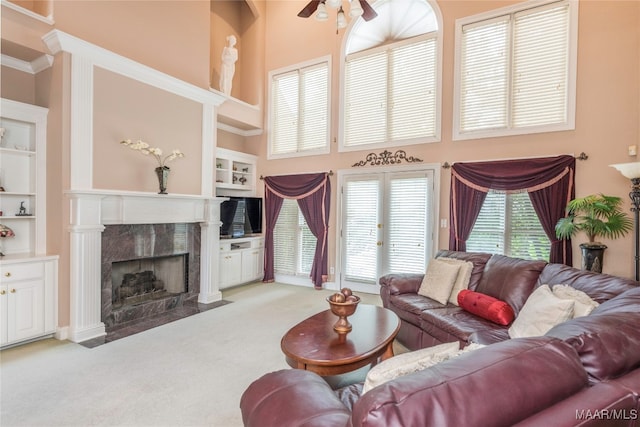 living room with plenty of natural light, a high ceiling, and built in shelves